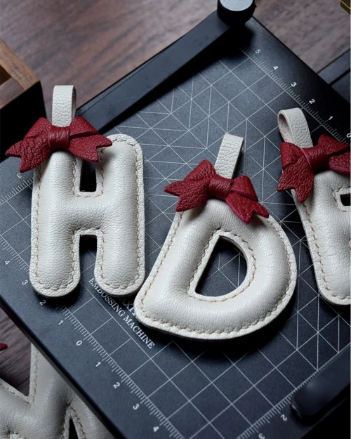 A festive letter bag charm handcrafted from French goatskin leather. Choose from 26 letters and create custom combinations, hand-stitched and gift boxed.