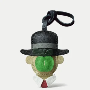 A surreal apple gentleman bag charm handcrafted from premium leather. Hand-stitched over three days and gift boxed for bags, keys, or car keys.