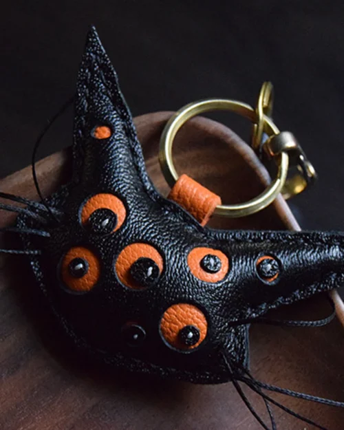 Cat bag charm handcrafted from French goatskin leather, hand-stitched over three days and gift boxed for bags, keys, or car key accessories.