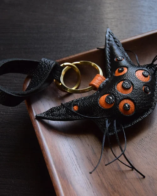 Cat bag charm handcrafted from French goatskin leather, hand-stitched over three days and gift boxed for bags, keys, or car key accessories.