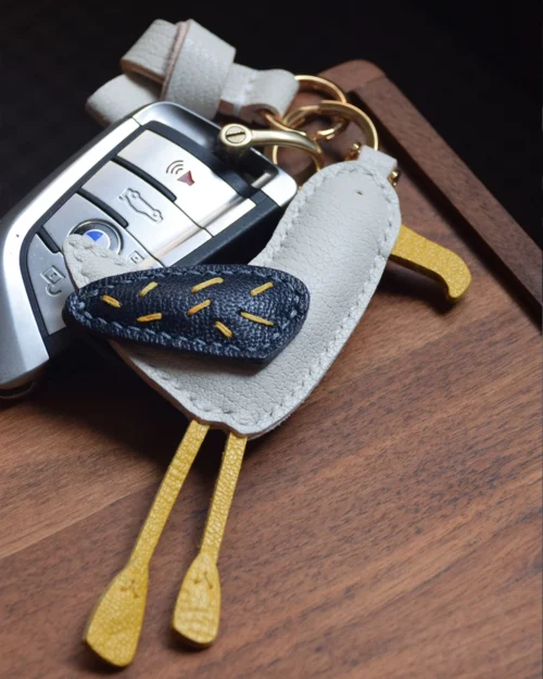 A whimsical seagull bag charm handcrafted from French goatskin leather. Hand-stitched over three days and gift boxed for bags, keys, or car keys.