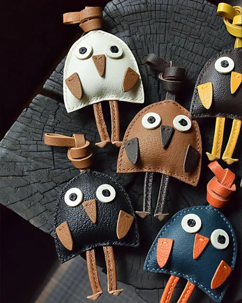 A playful bird bag charm handcrafted from French goatskin leather. Hand-stitched over three days and gift boxed for bags, keys, or car keys.
