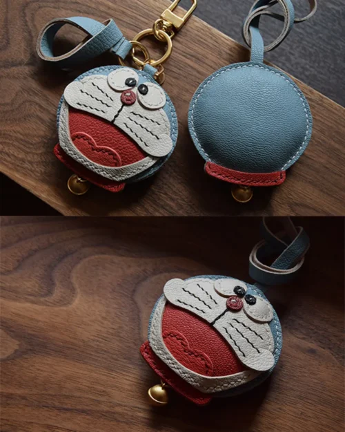 A playful Doraemon bag charm handcrafted from French goatskin leather. Hand-stitched over three days and gift boxed, perfect for bags, keys, or car keys.