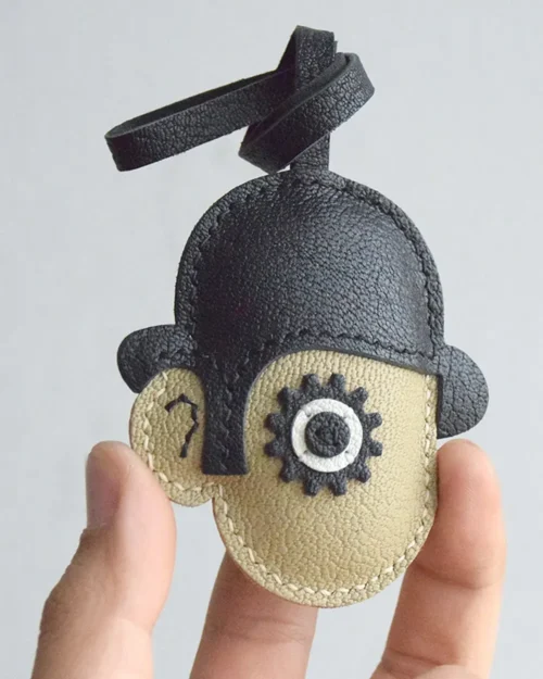 Clockwork Character bag charm handcrafted from premium leather. Hand-stitched over three days and gift boxed for bags, keys, or car keys.