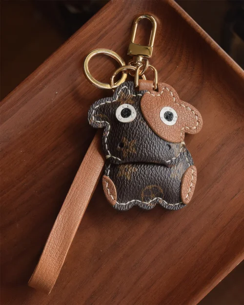 Cow Bag Charm handcrafted from French goatskin leather, hand-stitched over three days and gift boxed for bags, keys, and car key accessories.