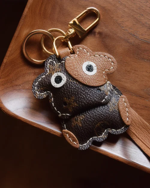 Cow Bag Charm handcrafted from French goatskin leather, hand-stitched over three days and gift boxed for bags, keys, and car key accessories.