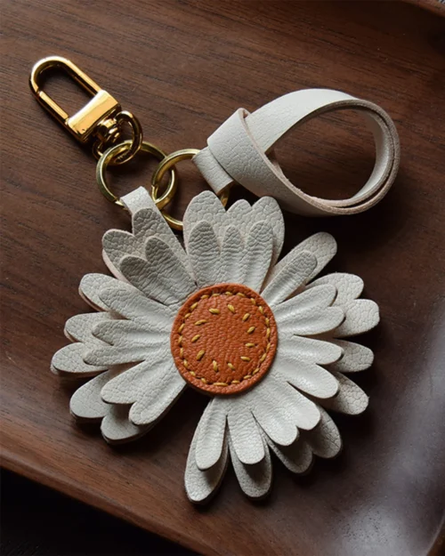 Daisy flower bag charm handcrafted from premium leather, hand-stitched over three days and gift boxed for bags, keys, or car key accessories.