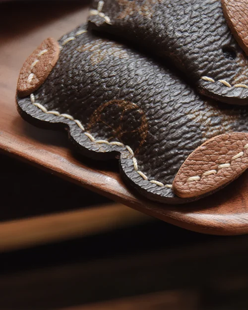 Cow Bag Charm handcrafted from French goatskin leather, hand-stitched over three days and gift boxed for bags, keys, and car key accessories.