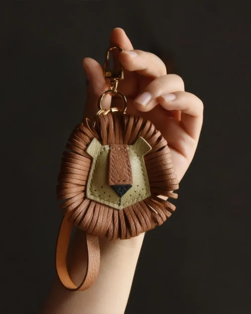 Lion Bag Charm handcrafted from French goatskin leather, hand-stitched over three days and gift boxed for bags, keys, and car key accessories.