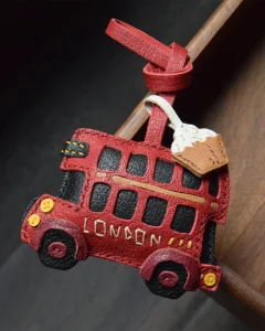 An iconic London bus bag charm handcrafted from French goatskin leather. Hand-stitched over three days and gift boxed, ideal for bags, keys, or car keys.