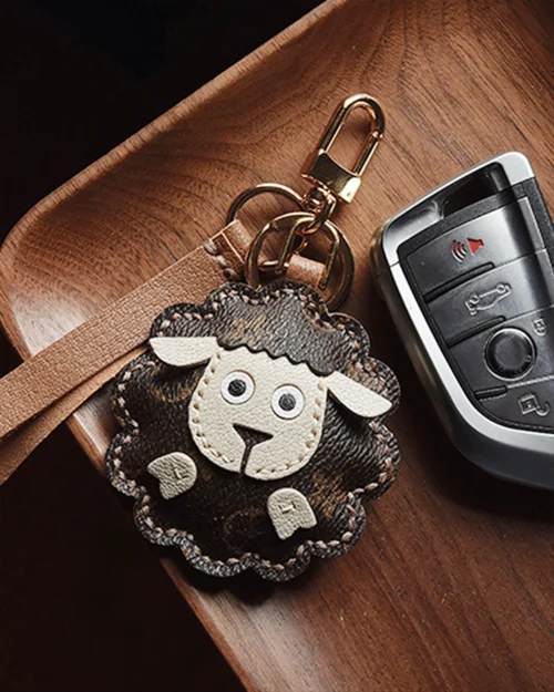 A cute sheep bag charm handcrafted from French goatskin leather. Hand-stitched over three days and gift boxed, perfect for bags, keys, or car keys.