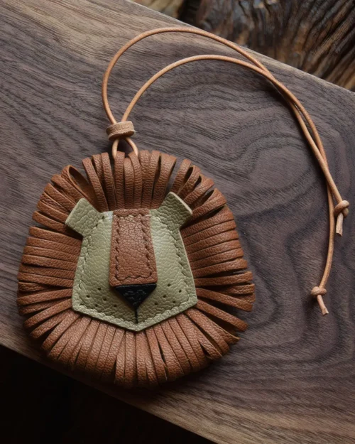 Lion Bag Charm handcrafted from French goatskin leather, hand-stitched over three days and gift boxed for bags, keys, and car key accessories.