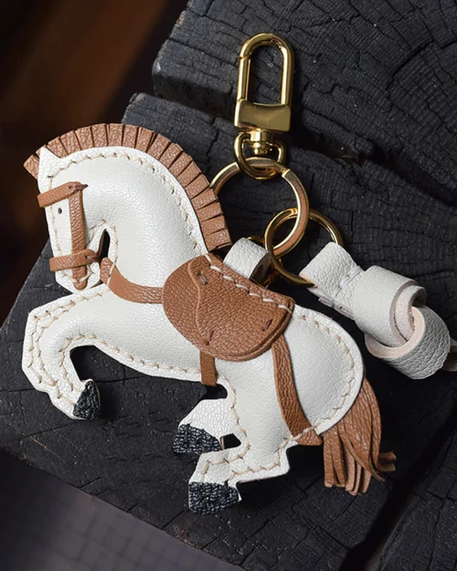 A handcrafted leather horse bag charm made from French goatskin. Hand-stitched over three days and gift boxed, ideal for bags, keys, or car keys.