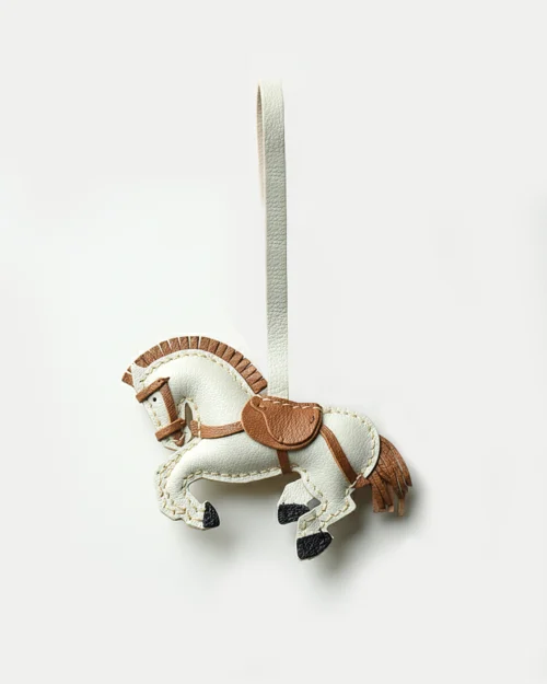 A handcrafted leather horse bag charm made from French goatskin. Hand-stitched over three days and gift boxed, ideal for bags, keys, or car keys.