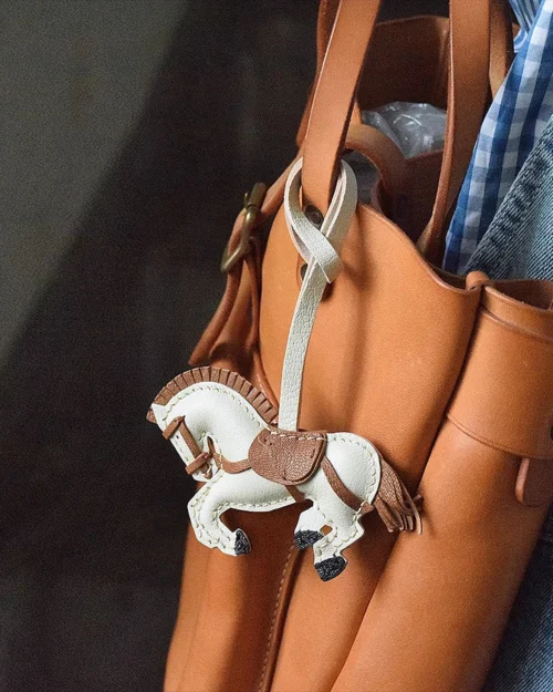 A handcrafted leather horse bag charm made from French goatskin. Hand-stitched over three days and gift boxed, ideal for bags, keys, or car keys.