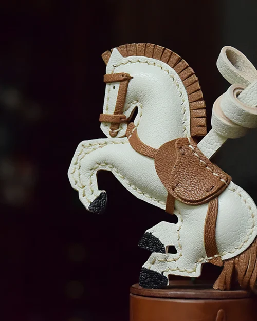 A handcrafted leather horse bag charm made from French goatskin. Hand-stitched over three days and gift boxed, ideal for bags, keys, or car keys.