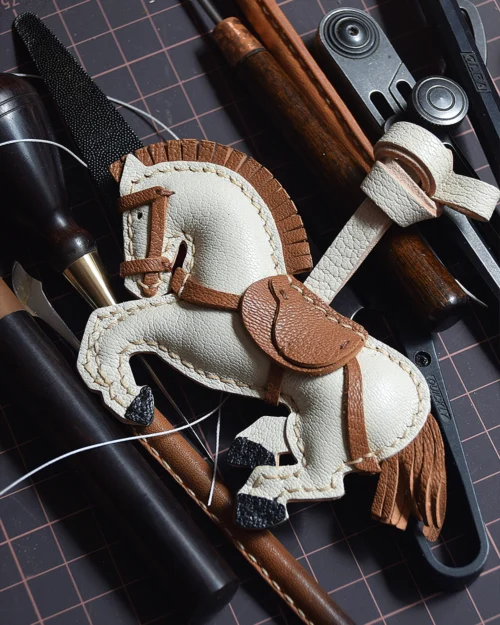 A handcrafted leather horse bag charm made from French goatskin. Hand-stitched over three days and gift boxed, ideal for bags, keys, or car keys.