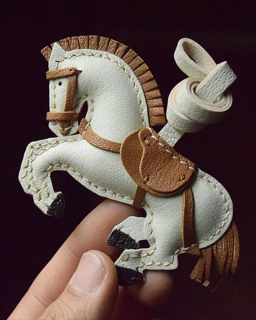 A handcrafted leather horse bag charm made from French goatskin. Hand-stitched over three days and gift boxed, ideal for bags, keys, or car keys.