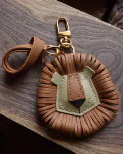 Lion Bag Charm handcrafted from French goatskin leather, hand-stitched over three days and gift boxed for bags, keys, and car key accessories.