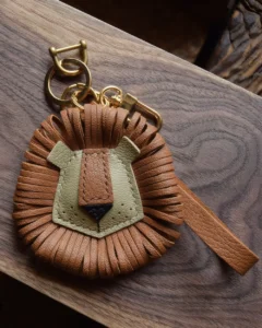 Lion Bag Charm handcrafted from French goatskin leather, hand-stitched over three days and gift boxed for bags, keys, and car key accessories.