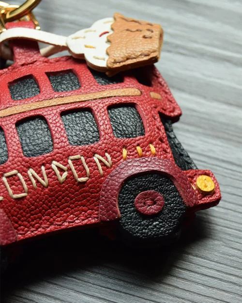 An iconic London bus bag charm handcrafted from French goatskin leather. Hand-stitched over three days and gift boxed, ideal for bags, keys, or car keys.