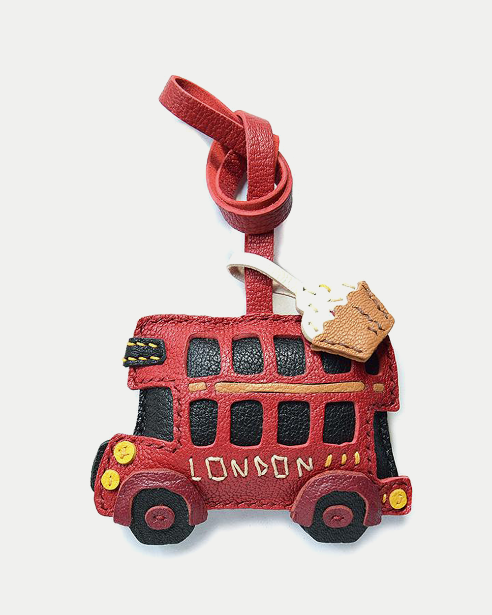 An iconic London bus bag charm handcrafted from French goatskin leather. Hand-stitched over three days and gift boxed, ideal for bags, keys, or car keys.
