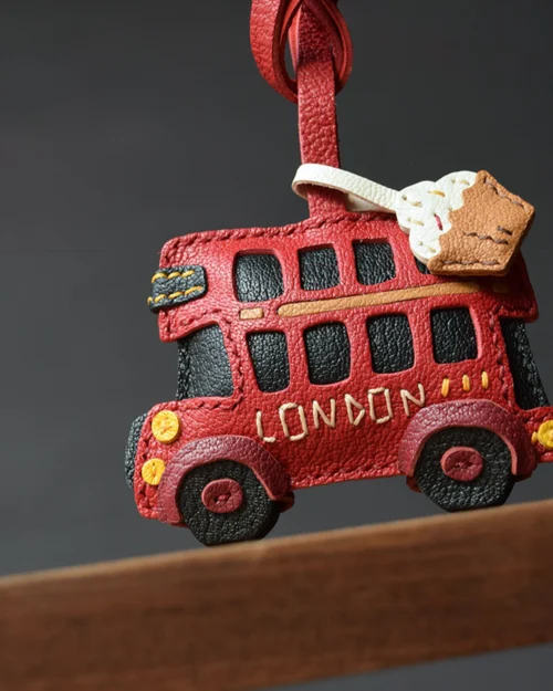 An iconic London bus bag charm handcrafted from French goatskin leather. Hand-stitched over three days and gift boxed, ideal for bags, keys, or car keys.