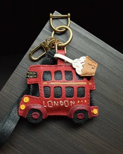 An iconic London bus bag charm handcrafted from French goatskin leather. Hand-stitched over three days and gift boxed, ideal for bags, keys, or car keys.