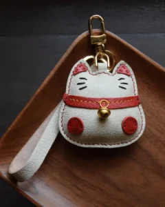 Lucky Cat Bag Charm handcrafted from French goatskin leather, hand-stitched over three days and gift boxed for bags, keys, and car key accessories.