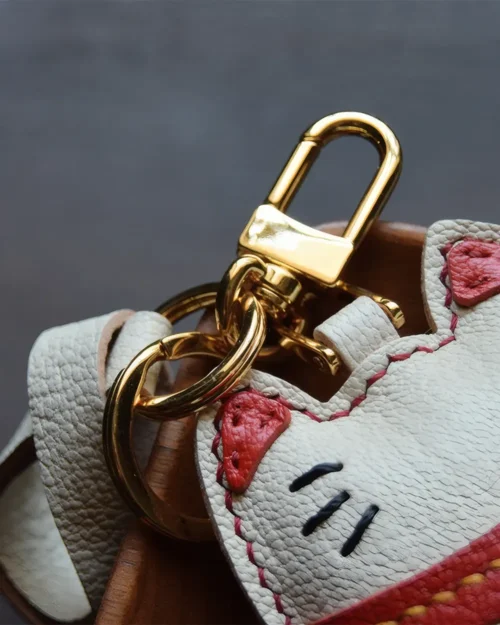 Lucky Cat Bag Charm handcrafted from French goatskin leather, hand-stitched over three days and gift boxed for bags, keys, and car key accessories.