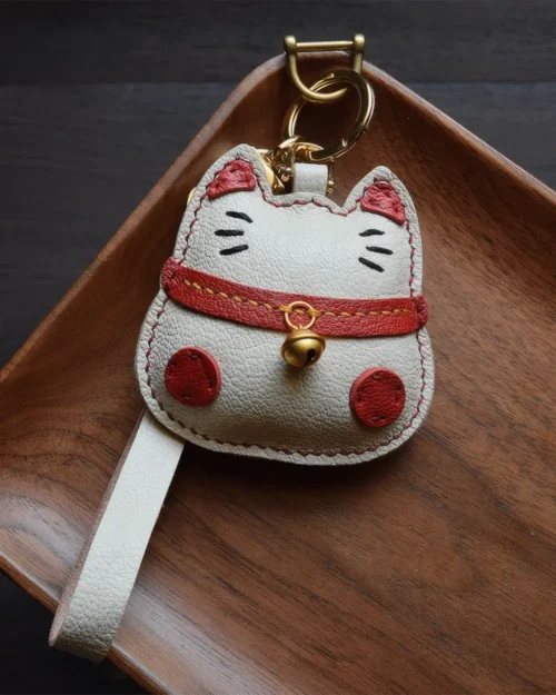 Lucky Cat Bag Charm handcrafted from French goatskin leather, hand-stitched over three days and gift boxed for bags, keys, and car key accessories.