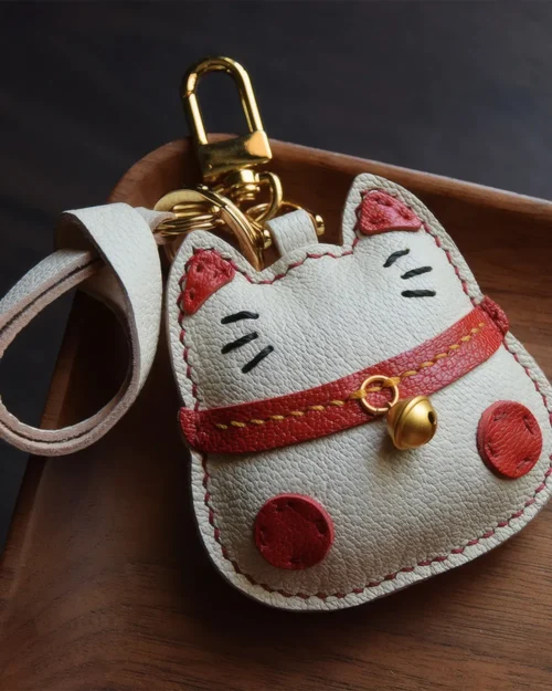 Lucky Cat Bag Charm handcrafted from French goatskin leather, hand-stitched over three days and gift boxed for bags, keys, and car key accessories.