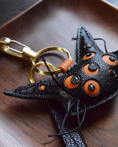 Cat bag charm handcrafted from French goatskin leather, hand-stitched over three days and gift boxed for bags, keys, or car key accessories.