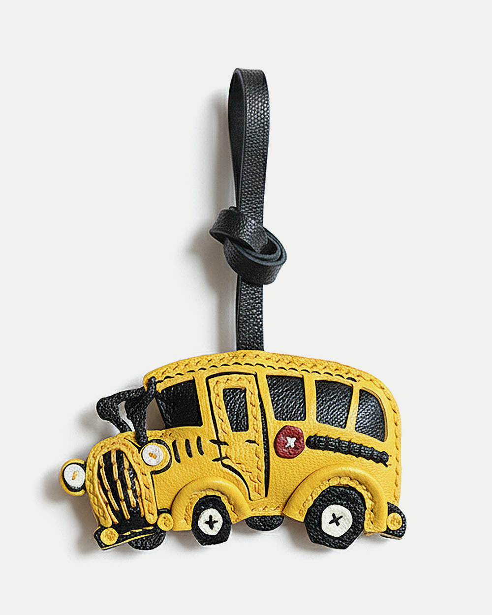 A cheerful school bus bag charm handcrafted from French goatskin leather. Hand-stitched over three days and gift boxed, ideal for bags, keys, or car keys.