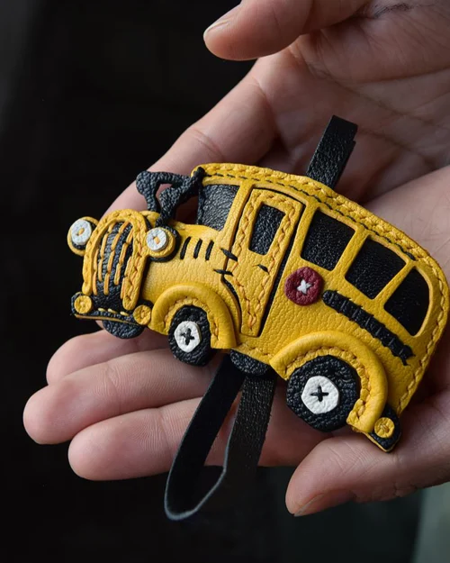 A cheerful school bus bag charm handcrafted from French goatskin leather. Hand-stitched over three days and gift boxed, ideal for bags, keys, or car keys.