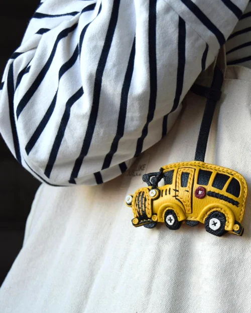 A cheerful school bus bag charm handcrafted from French goatskin leather. Hand-stitched over three days and gift boxed, ideal for bags, keys, or car keys.