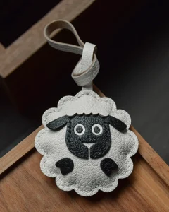 A cute sheep bag charm handcrafted from French goatskin leather. Hand-stitched over three days and gift boxed, perfect for bags, keys, or car keys.
