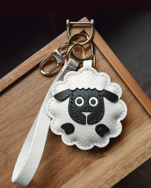 A cute sheep bag charm handcrafted from French goatskin leather. Hand-stitched over three days and gift boxed, perfect for bags, keys, or car keys.