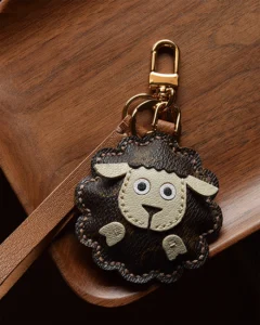 A cute sheep bag charm handcrafted from French goatskin leather. Hand-stitched over three days and gift boxed, perfect for bags, keys, or car keys.