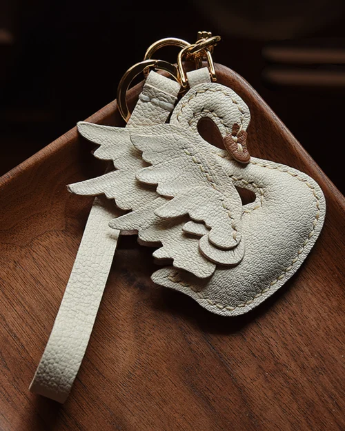 An elegant swan bag charm handcrafted from French goatskin leather. Hand-stitched over three days and gift boxed, ideal for bags, keys, or car keys.