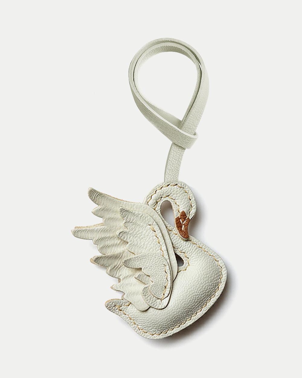 An elegant swan bag charm handcrafted from French goatskin leather. Hand-stitched over three days and gift boxed, ideal for bags, keys, or car keys.