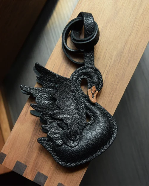 An elegant swan bag charm handcrafted from French goatskin leather. Hand-stitched over three days and gift boxed, ideal for bags, keys, or car keys.