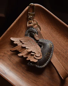 An elegant swan bag charm handcrafted from French goatskin leather. Hand-stitched over three days and gift boxed, ideal for bags, keys, or car keys.