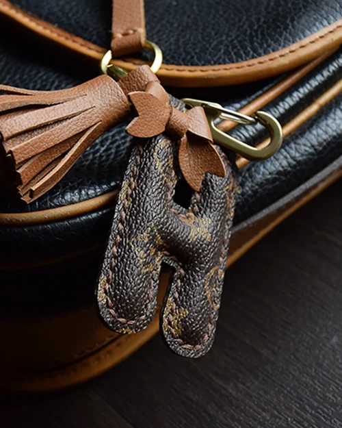 A handcrafted leather letter bag charm with tassel detail. Made by hand over three days, gift-boxed and perfect for bags, keys, or car keys. Choose your letter at checkout.