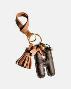 A handcrafted leather letter bag charm with tassel detail. Made by hand over three days, gift-boxed and perfect for bags, keys, or car keys. Choose your letter at checkout.