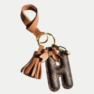 A handcrafted leather letter bag charm with tassel detail. Made by hand over three days, gift-boxed and perfect for bags, keys, or car keys. Choose your letter at checkout.