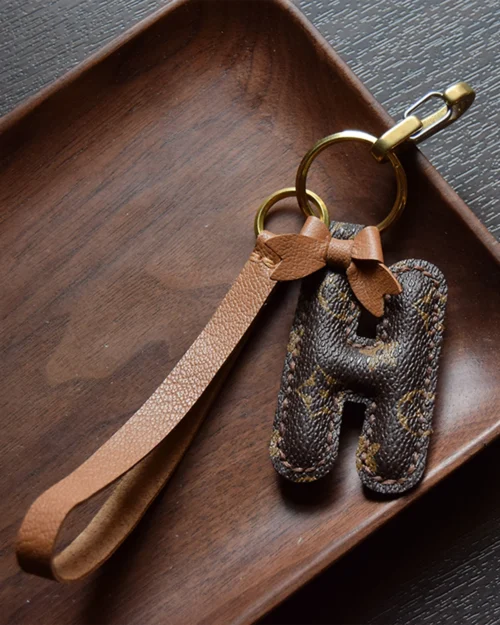 A handcrafted leather letter bag charm with tassel detail. Made by hand over three days, gift-boxed and perfect for bags, keys, or car keys. Choose your letter at checkout.