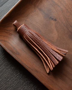 Keychain accessory components set featuring brass hardware, leather tassels, cords, and connectors for bag charms, keychains, and car key accessories.