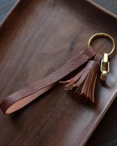 Leather Tassel Bag Charm handcrafted from premium leather. Hand-stitched over three days and gift boxed for bags, keys, or car keys.