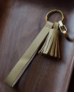 Leather Tassel Bag Charm handcrafted from premium leather. Hand-stitched over three days and gift boxed for bags, keys, or car keys.